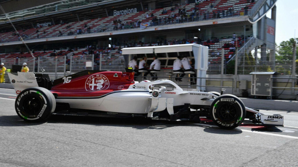 Alfa Romeo Formula 1 car with Charles Leclerc number at Barcelona circuit vibrant wallpaper background