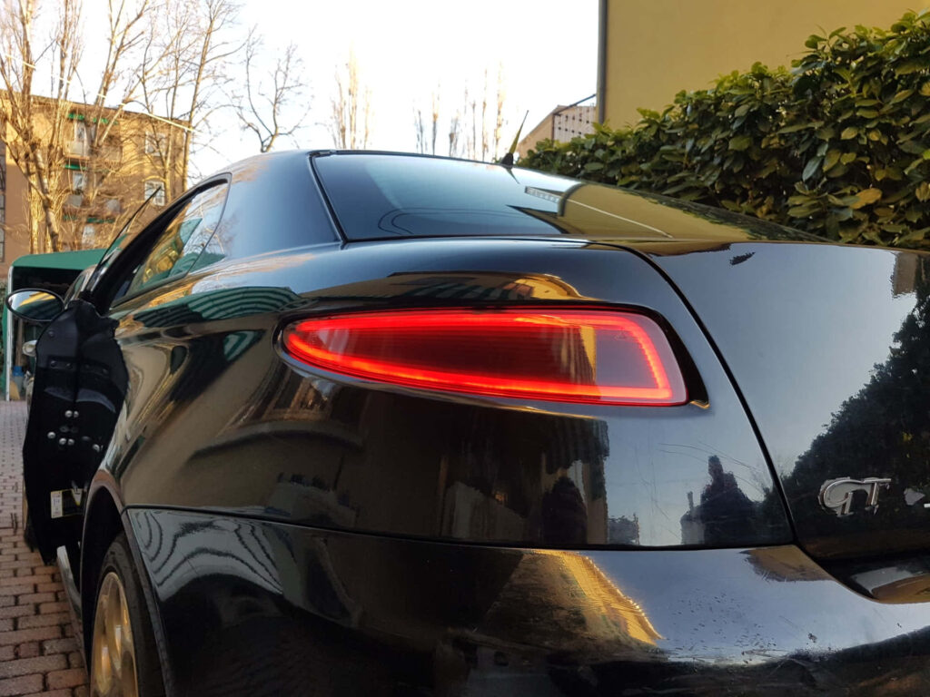 Glossy black Alfa Romeo GT rear view showcasing elegant curves and sporty sleek design wallpaper