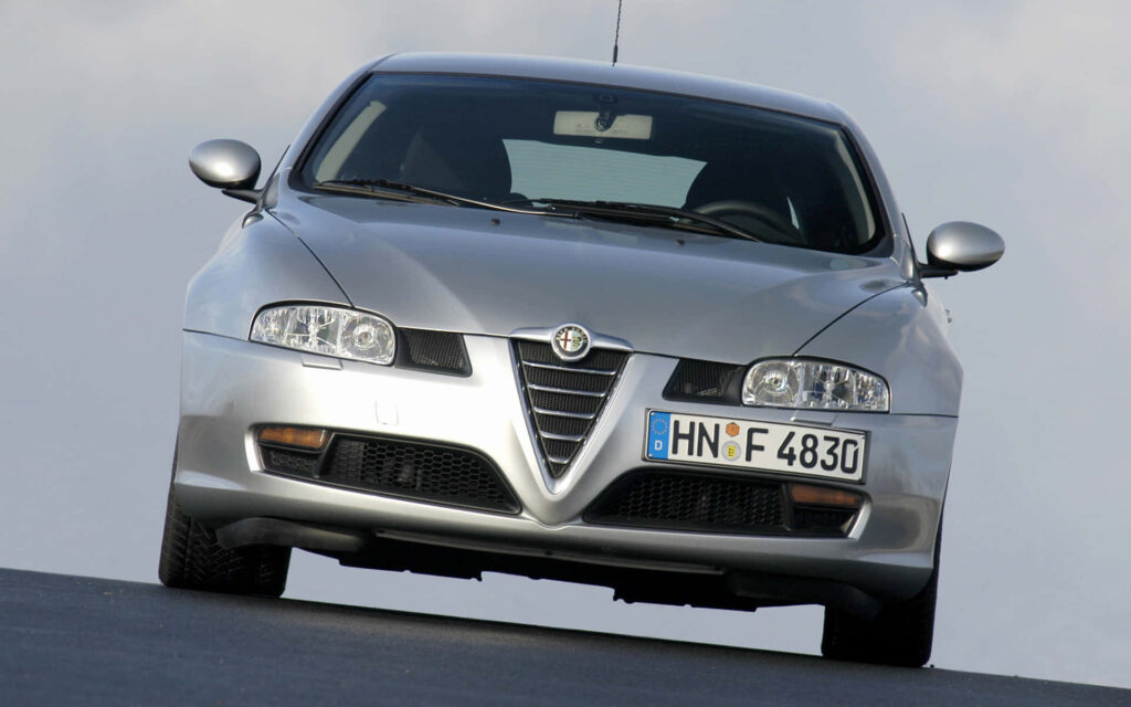 Silver Alfa Romeo GT with distinctive front grille sleek design on blurred background wallpaper