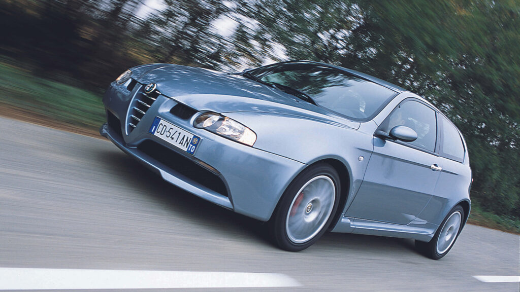 Alfa Romeo GT speeding on scenic road dynamic wallpaper showcasing sleek design and performance