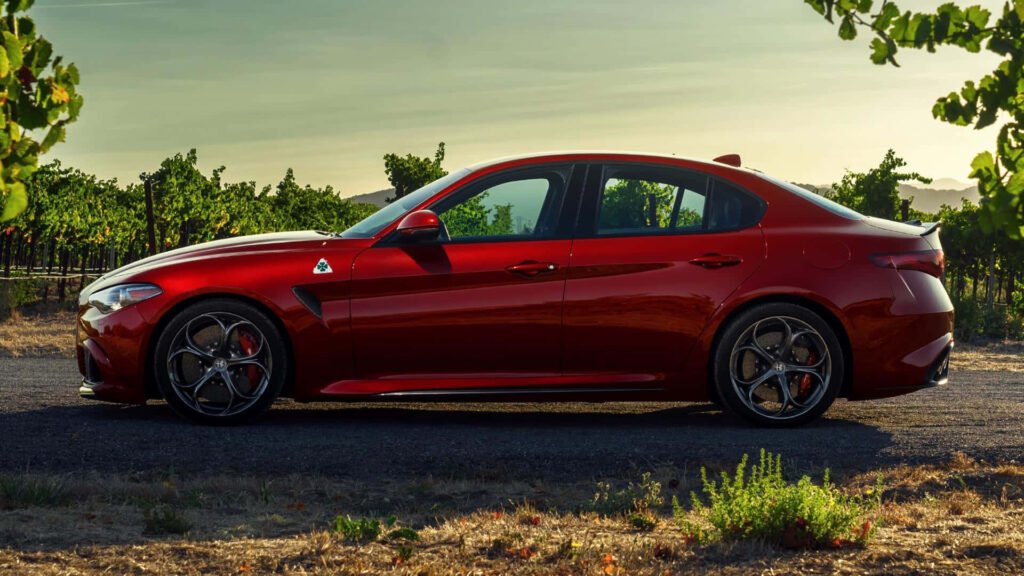 Alfa Romeo Giulia in sunlight showcasing elegant silhouette and dynamic curves scenic background Wallpaper