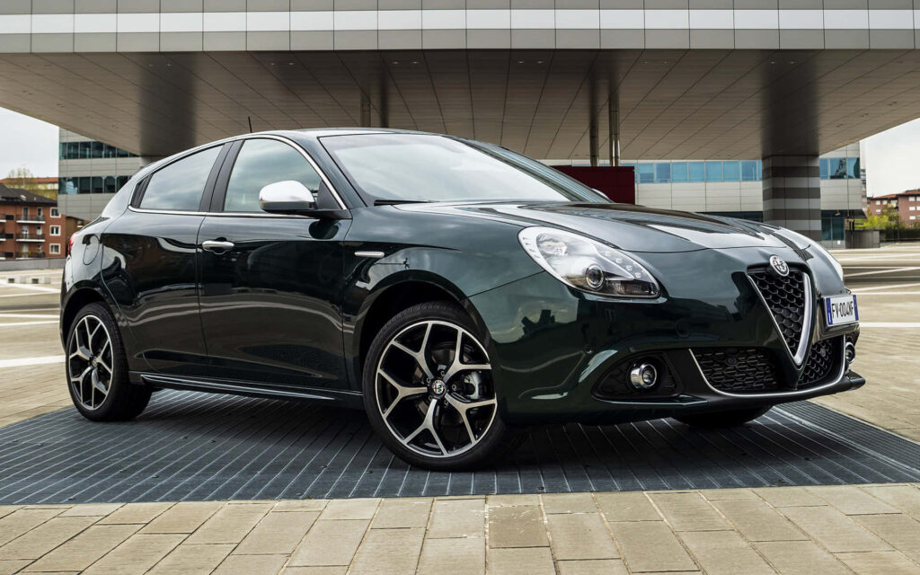 Sleek Alfa Romeo Giulietta on urban road showcasing modern design and dynamic presence wallpaper