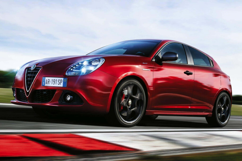 Red Alfa Romeo Giulietta speeding on highway dynamic design sport car high energy wallpaper background