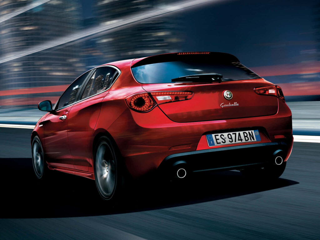 Alfa Romeo Giulietta red sporty car cruising city streets dynamic wallpaper background