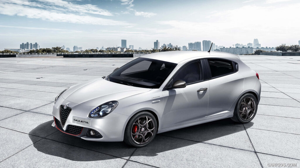 Alfa Romeo Giulietta sporty car parked in open area with city skyline modern design wallpaper