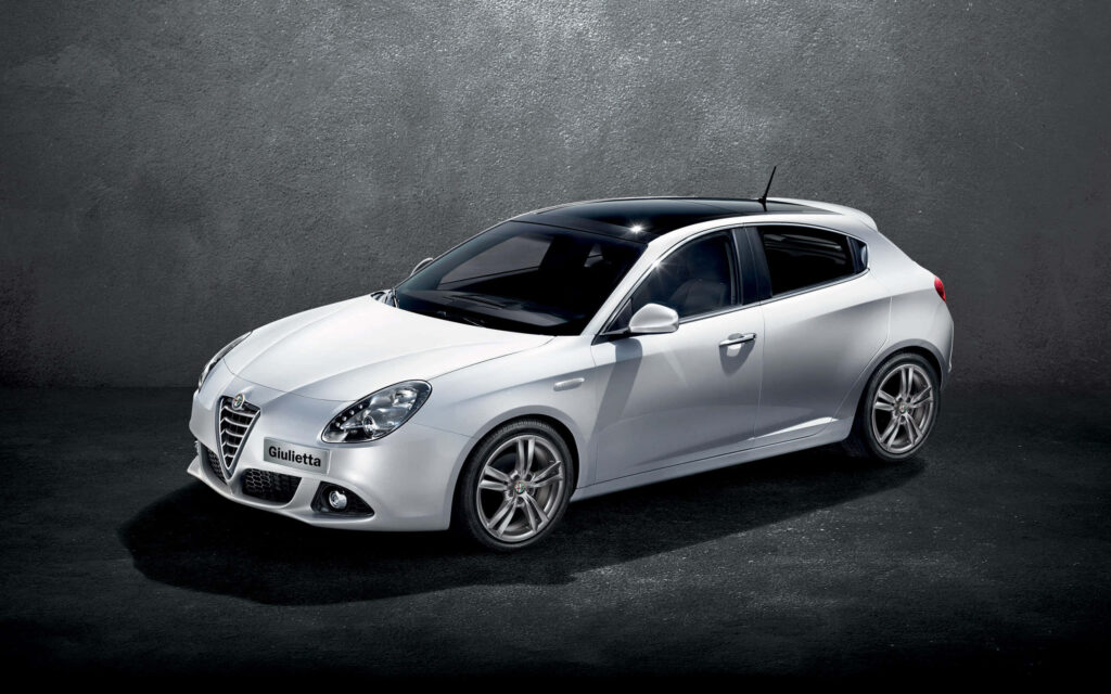 Alfa Romeo Giulietta on open road showcasing elegant design sporty contours wallpaper background