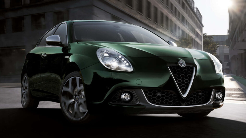 Alfa Romeo Giulietta driving on city road showcasing sleek modern design and dynamic style Wallpaper