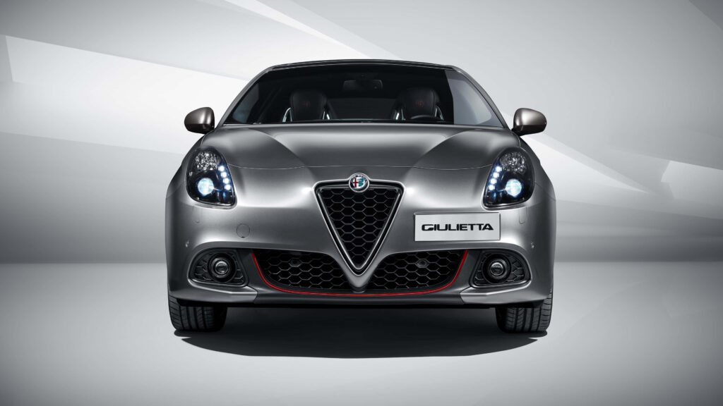 Alfa Romeo Giulietta on road with sleek design and bold grille dynamic car wallpaper background