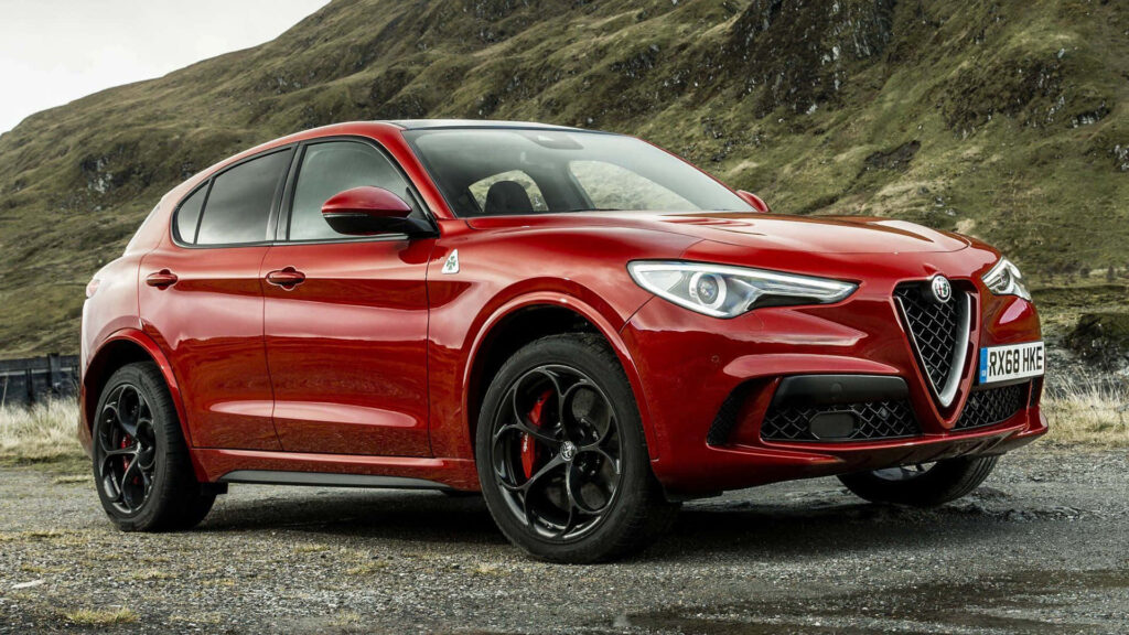 Alfa Romeo Stelvio parked with rolling green hills in background showcasing bold design Wallpaper