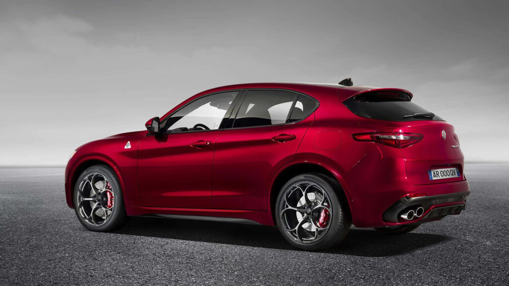 Alfa Romeo Stelvio in motion on open road with dynamic design and dramatic sky background Wallpaper