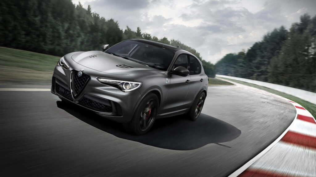 Alfa Romeo Stelvio luxury SUV speeding on race track showing sleek design and dynamic performance Wallpaper