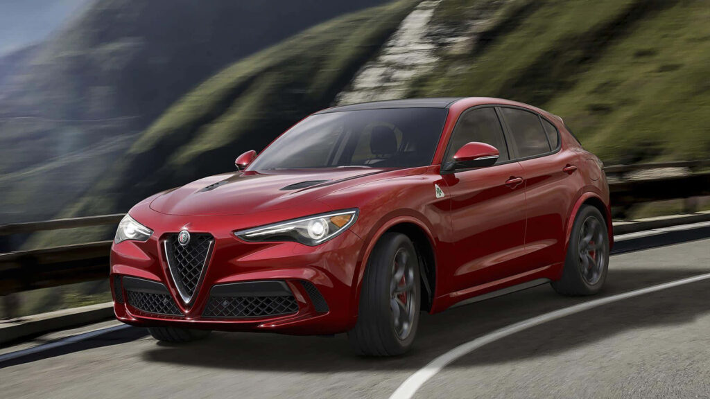 Alfa Romeo Stelvio red SUV driving on scenic mountain road sleek design wallpaper background