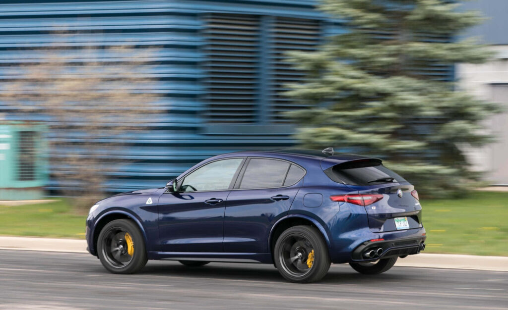 Alfa Romeo Stelvio in motion showcasing sporty elegance and powerful performance urban backdrop Wallpaper