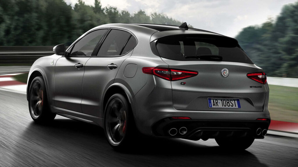 Alfa Romeo Stelvio driving through forest with aerodynamic design and dynamic curves wallpaper