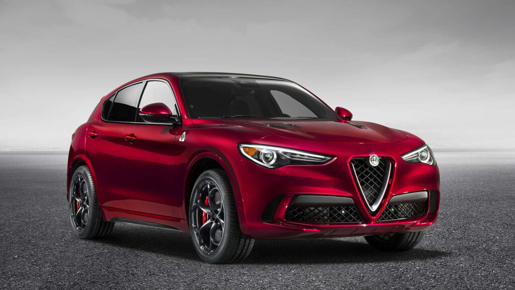 Alfa Romeo Stelvio on scenic road showcasing sleek design and dynamic luxury SUV profile Wallpaper