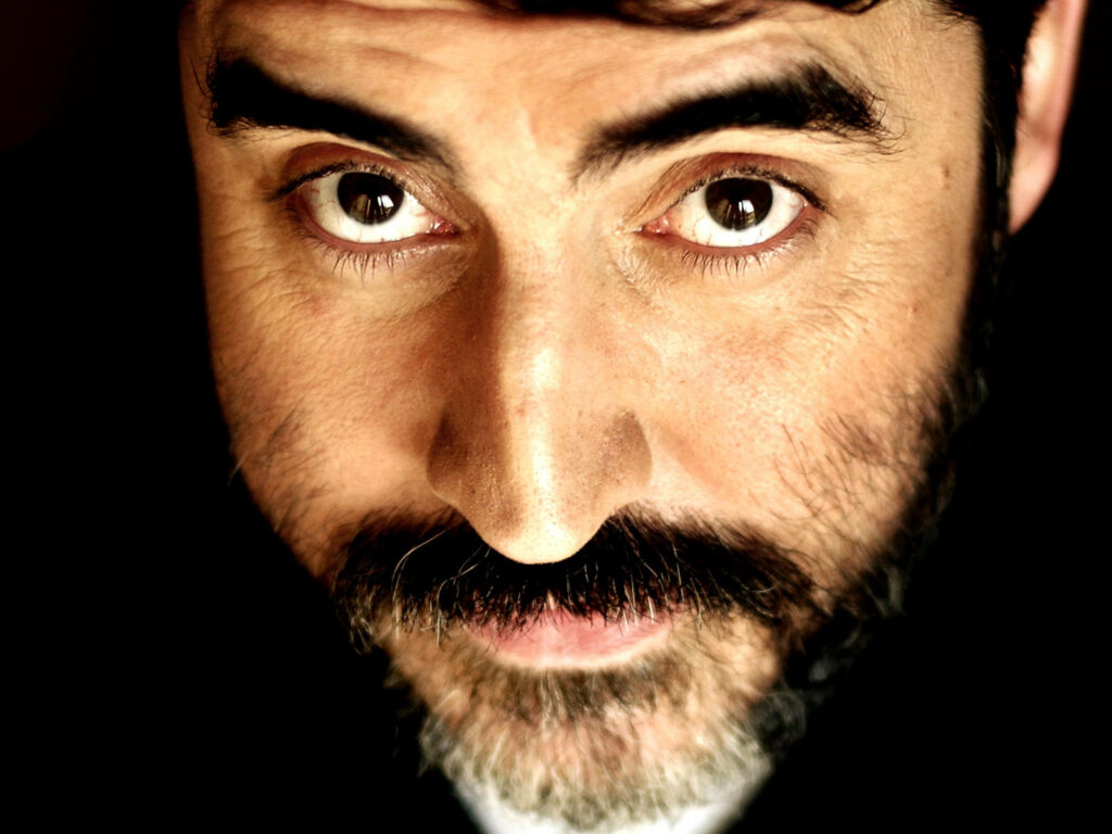 Close-up portrait of Alfred Molina with expressive eyes and distinctive facial features wallpaper