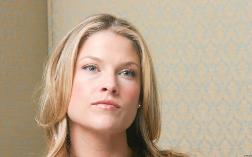 American actress Ali Larter posing gracefully with elegant expression against patterned wallpaper