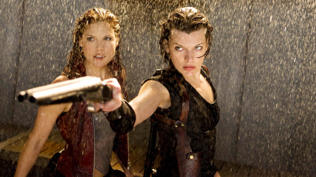 Actress Ali Larter in intense rainy action scene holding weapon with co-star dramatic film moment Wallpaper