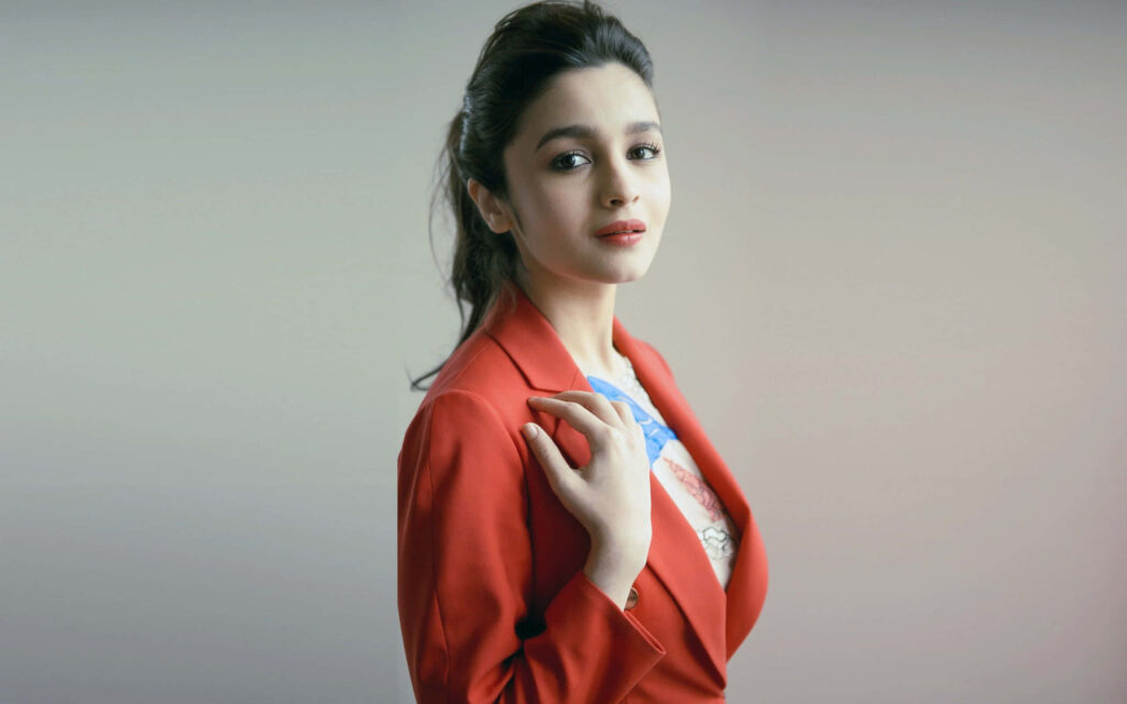 Alia Bhatt in stylish red blazer confidently posing with elegant optimistic expression wallpaper background