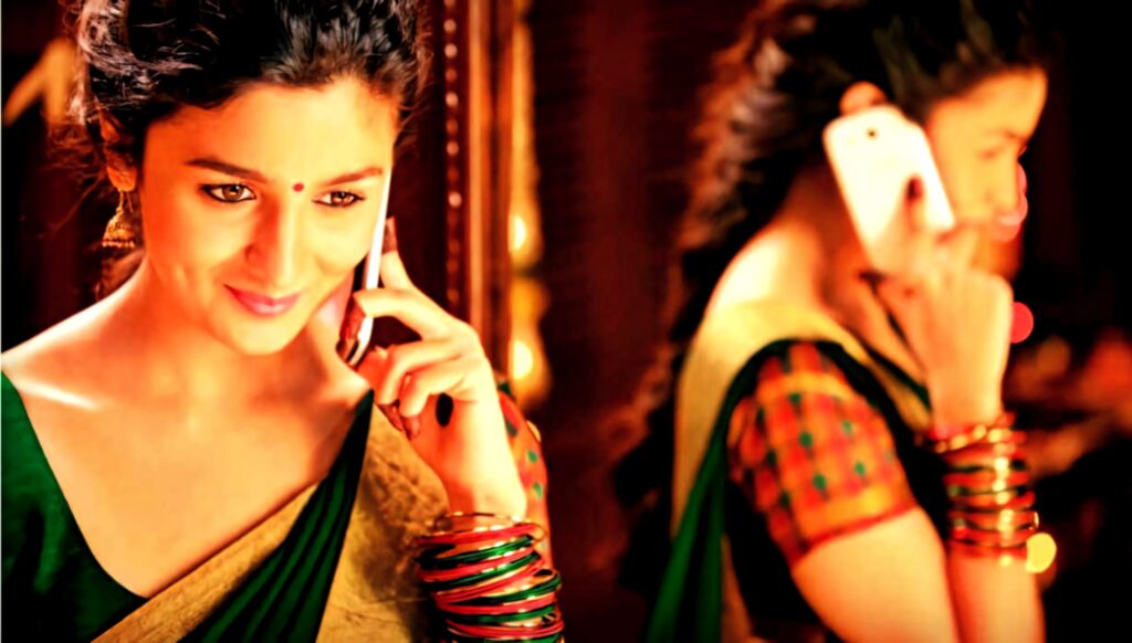 Alia Bhatt in traditional saree with colorful bangles smiling and talking on phone vibrant wallpaper
