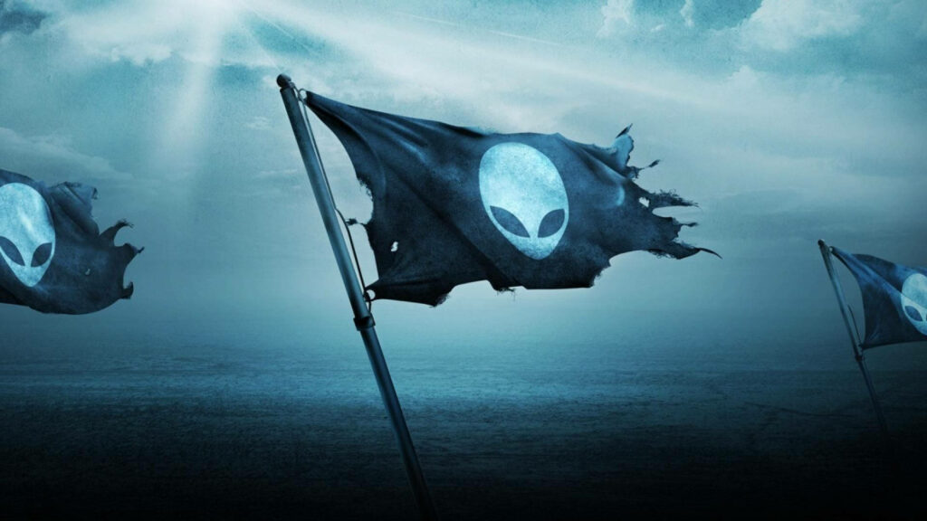 Weathered Alienware flag with alien head logo waves over misty blue landscape gaming wallpaper