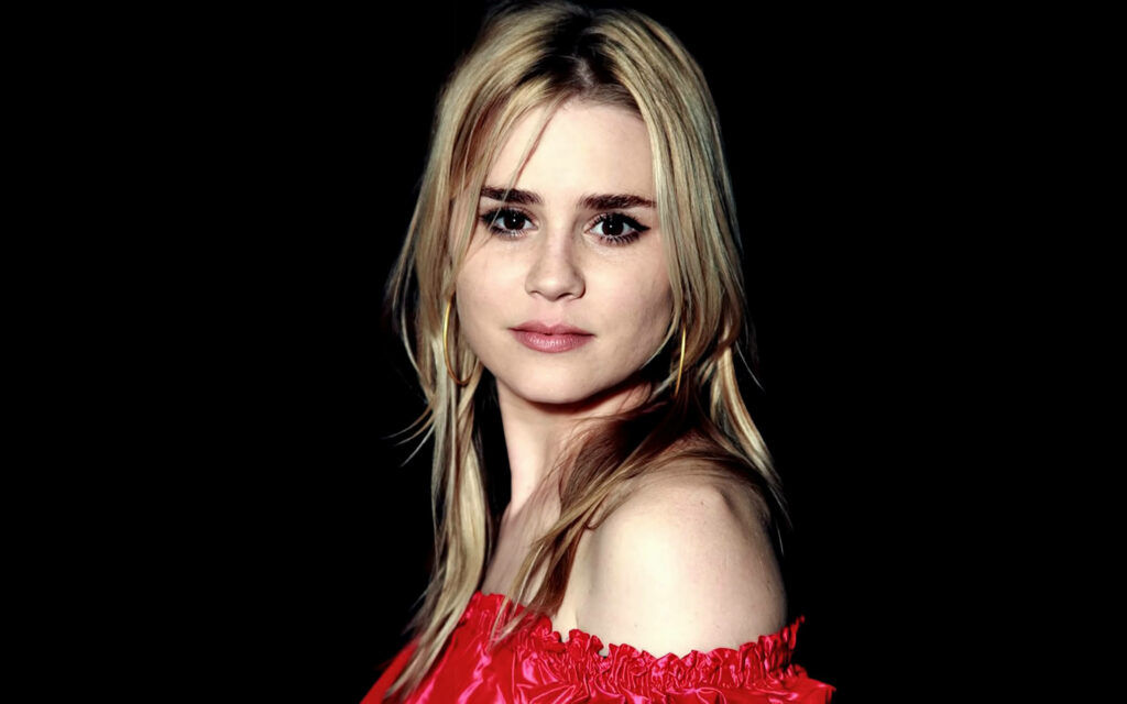 Alison Lohman in off-shoulder red top with blonde hair against deep black background wallpaper