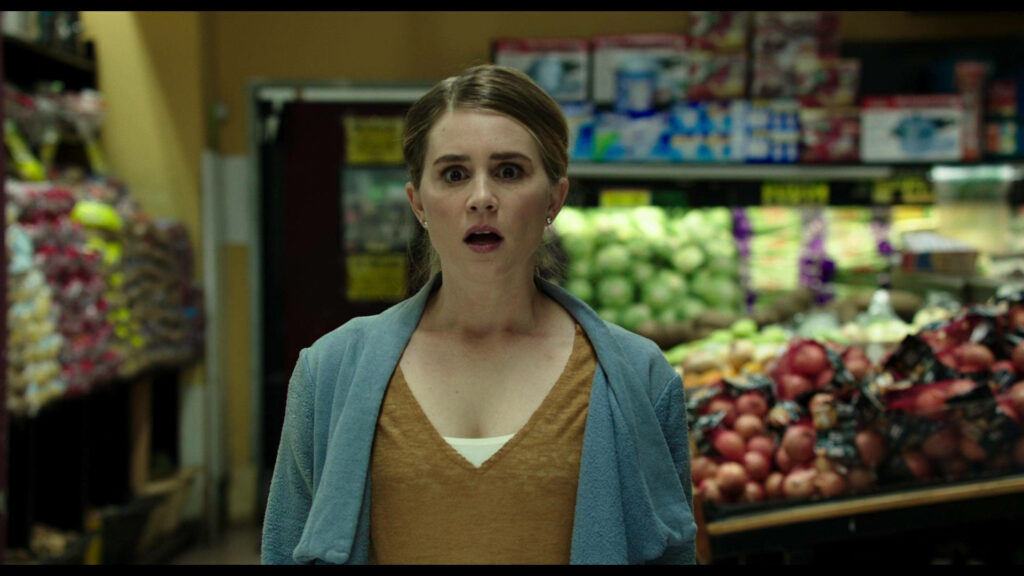 Alison Lohman surprised in grocery aisle with colorful produce scene from Urge 2016 film Wallpaper