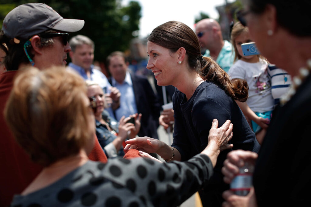 Alison Lundergan Grimes smiling and warmly greeting supporters outdoors in public setting Wallpaper