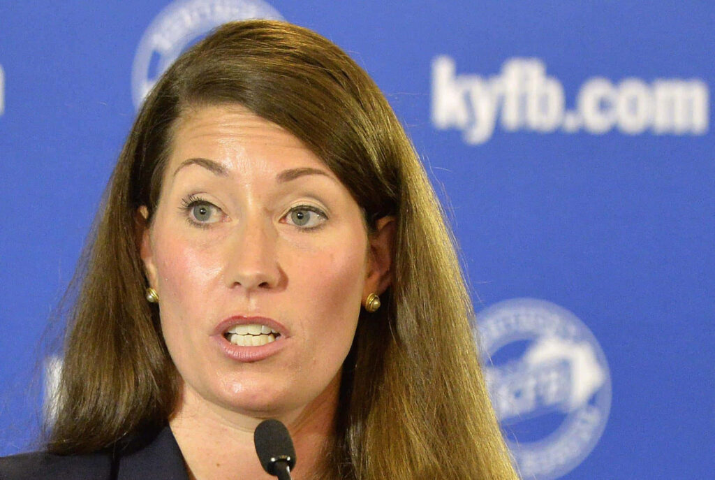 Alison Lundergan Grimes speaking with determination blue background focused leadership portrait Wallpaper