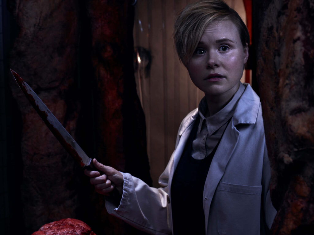 Alison Pill in white lab coat holding bloodstained knife dramatic dark intense portrait wallpaper