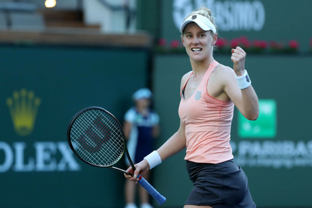 Alison Riske Amritraj fist pumps on tennis court showing determination and energy wallpaper