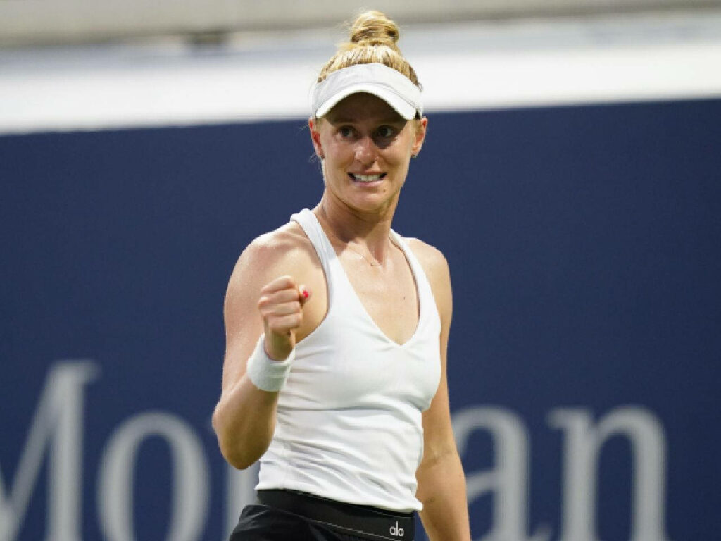 Alison Riske-Amritraj celebrating on tennis court wearing white tank top showing focus and determination Wallpaper