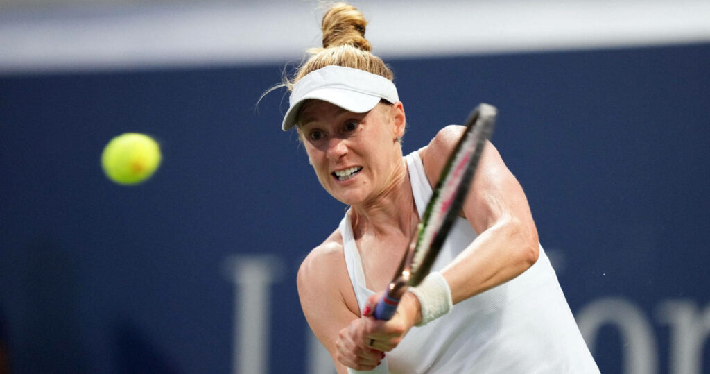 Alison Riske-Amritraj focused hitting backhand tennis shot in white athletic attire on court Wallpaper