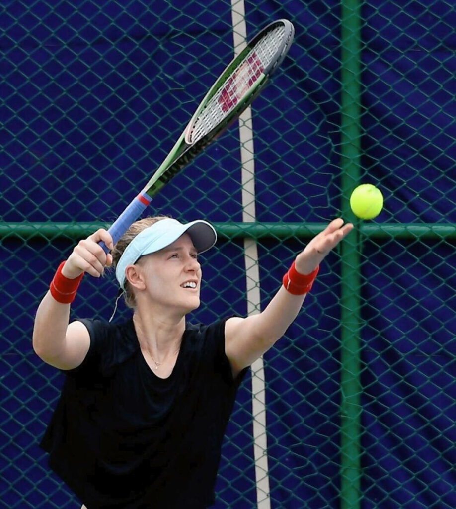 Alison Riske-Amritraj powerful tennis serve in action on court dynamic sports wallpaper background
