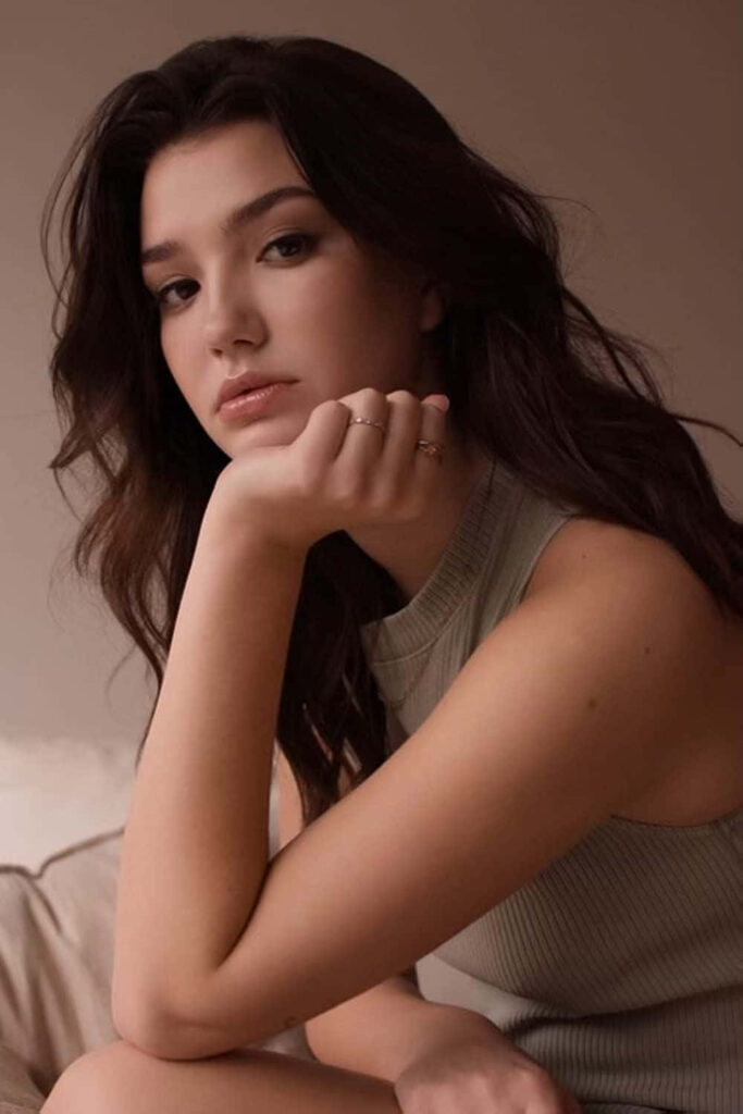 Contemplative portrait of Alissa Skovbye in soft lighting with neutral tones calm mood wallpaper
