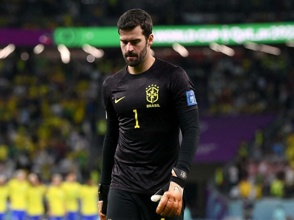 Alisson Becker Brazil goalkeeper focused in kit ready for high stakes soccer match background Wallpaper