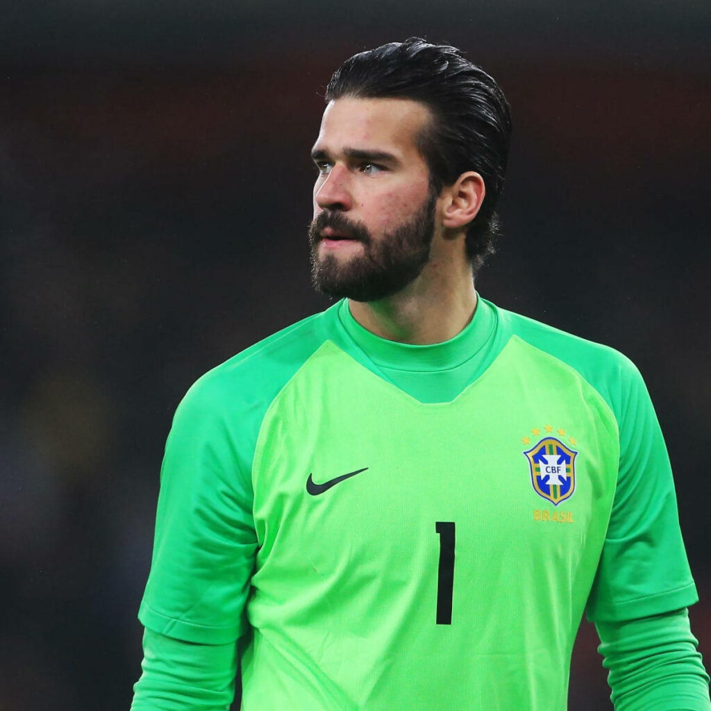 Alisson Becker in bright green Brazil goalkeeper jersey focused on football field dynamic wallpaper