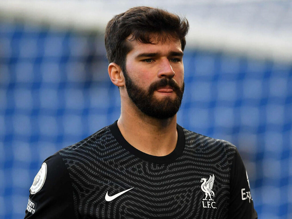 Alisson Becker focused on field in Liverpool jersey licking lips candid match moment wallpaper
