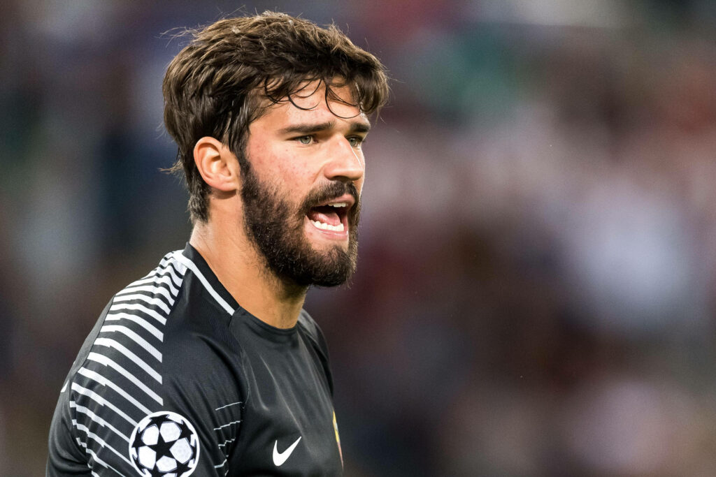 Alisson Becker intense focused mid-sentence dynamic football goalkeeper wallpaper background