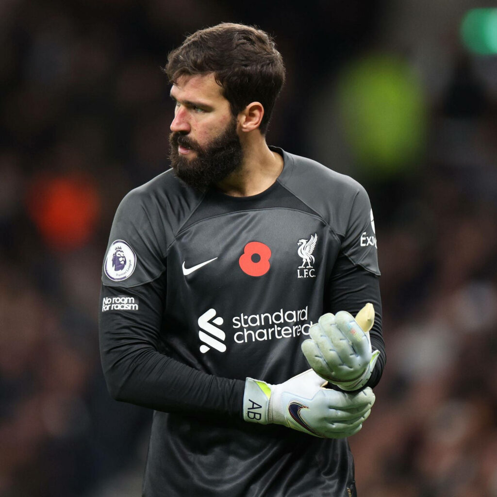 Alisson Becker Liverpool goalkeeper focused in kit showing determination and leadership on field Wallpaper