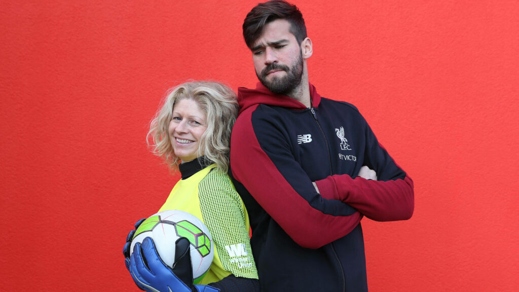 Alisson Becker and Alyson Rudd with football and gloves against vibrant red background wallpaper