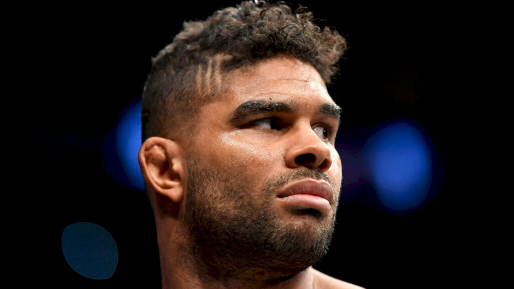 Alistair Overeem intense focused side view MMA fighter against dark blurred background wallpaper