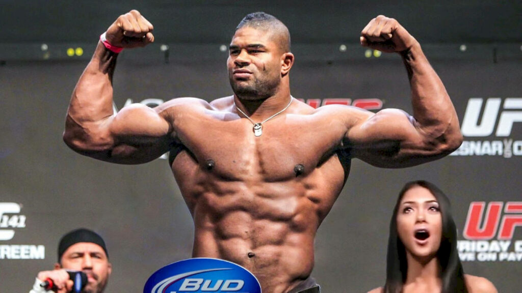 Alistair Overeem flexing muscular biceps on stage showcasing strength and powerful physique wallpaper