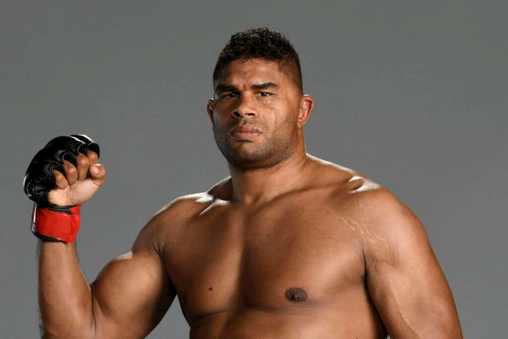 Alistair Overeem flexing muscular arm showing intense strength and power wallpaper background