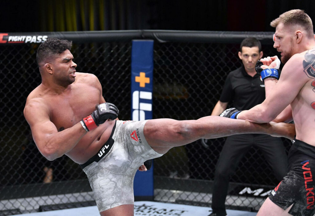 Alistair Overeem delivers powerful kick UFC fight octagon intense mixed martial arts wallpaper