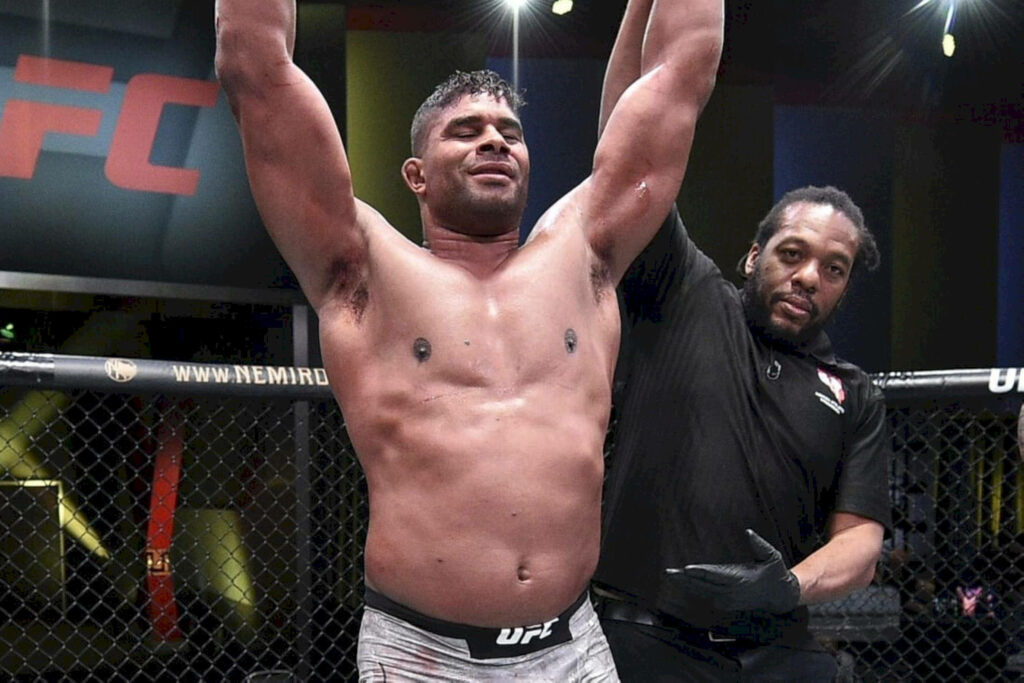 Alistair Overeem celebrating UFC victory with referee raising his hand inside the octagon Wallpaper