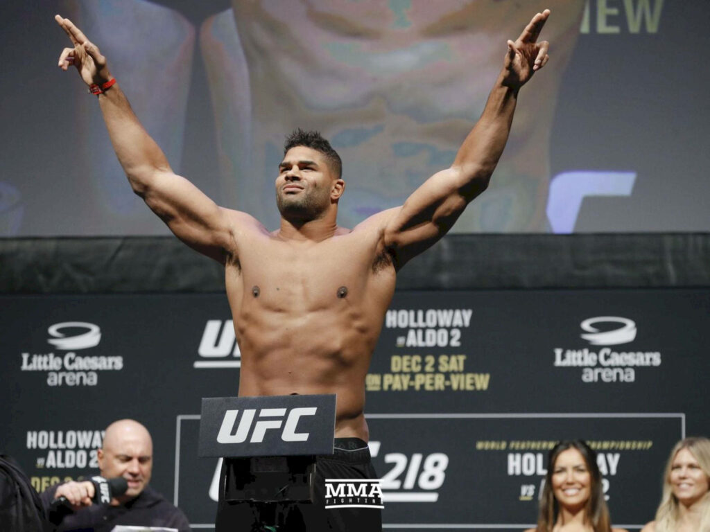 Alistair Overeem UFC weigh-in confident pose with raised arms and muscular physique background Wallpaper
