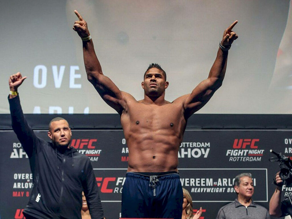 Alistair Overeem victorious with hands raised strong confident MMA fighter on stage wallpaper