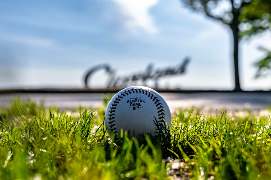 Champion On The Green: A Spectacular All-Star Baseball Wallpaper with a Close-Up of the Game on a Gorgeous Daytime Background