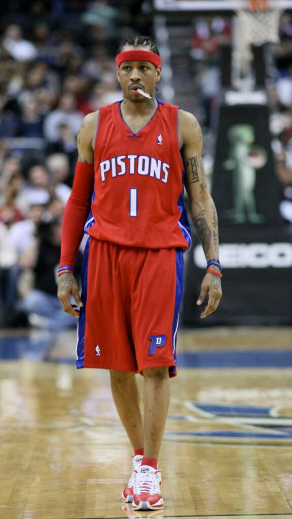 Allen Iverson in Detroit Pistons jersey confidently poised on basketball court dynamic wallpaper